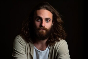 Young bearded male studio portraits Young man with long dark hair and beard portrait