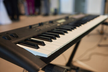 A pianist in a suit plays the keyboard with skilled hands