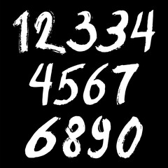 Set of calligraphic numbers painted by white brush on isolated black background. Lettering for your design. Vector illustration.