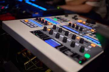 Hands playing buttons on an electronic keyboard mixer