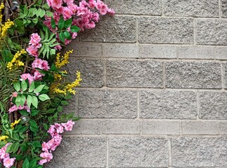 Flowers in the corner of a stone wall with copy space.