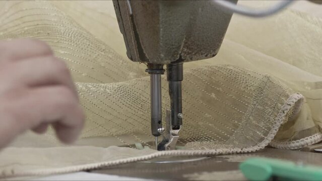 Tailor Sews Net Curtain with Sewing Machine Needle Footage.