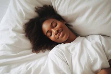 a black woman lies in bed. white linens. dream. cheerful morning. good dream. soft bed. orthopedic mattress