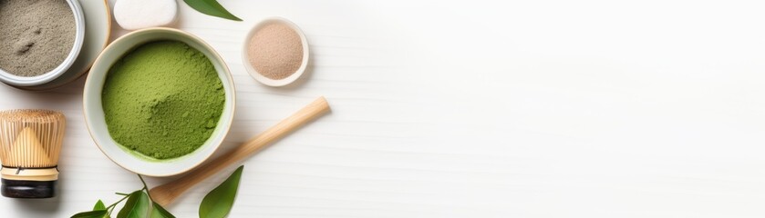 Matcha powder and tea ceremony tools arranged on a white background