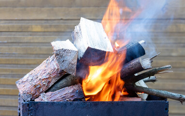A fire of logs in a brazier to produce coals.