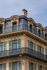 Architectural fragments of the facades of ancient houses in Nice: beautiful windows, balconies, shutters. Nice, capital of the Alpes-Maritimes department on the French Riviera.