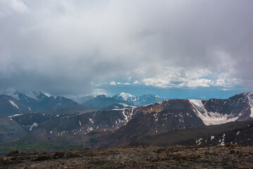 Dramatic alpine top view to rocky ridge and large mountain range with most beautiful snow-capped...