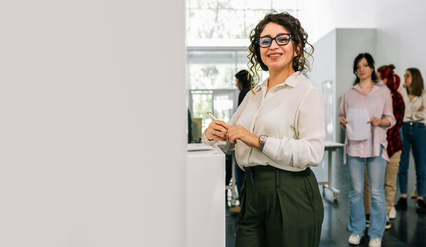 Hispanic voter placing ballot in ballot box polling place in America.