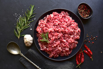 Homemade minced meat with ingredients for making in a bowl . Top view.