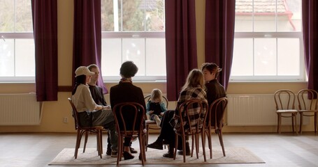 People sit in a circle. Setting fosters open communication, sense of inclusivity. Pedagogical...