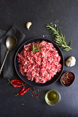Homemade minced meat with ingredients for making in a bowl . Top view.