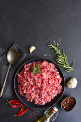 Homemade minced meat with ingredients for making in a bowl . Top view.