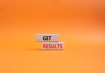 Get results symbol. Wooden blocks with words Get results. Beautiful orange background. Business and...