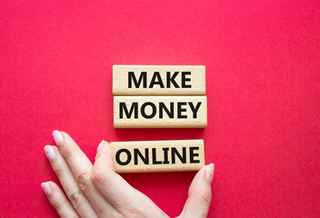 Make Money Online symbol. Concept words Make Money Online on wooden blocks. Businessman hand....