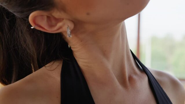 Woman Does Stretching Neck Relaxation Exercise