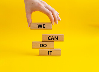 We can do it symbol. Concept words We can do it on wooden blocks. Beautiful yellow background....