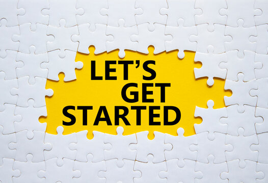 Lets get started symbol. Concept words Lets get started on white puzzle. Beautiful yellow background. Business and Lets get started concept. Copy space.