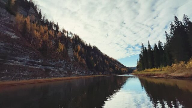Perm Region, Usva - September 2023. Boat trip to the Usva pillars. A view of the flashing autumn trees and the lapping of the waves from a boat sailing down the river.4К