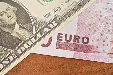 Comparison of dollar bill with euro, concept of inflation or abundance