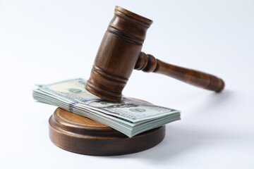 Law gavel with stack of dollars on white background