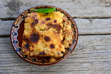  Bulgarian moussaka.Potato and minced meat  Casserole  with   parmesan cheese and garlic on wooden rustic bakcground.  