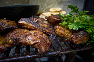A plate of food with chicken, arepa and vegetables on a grill
