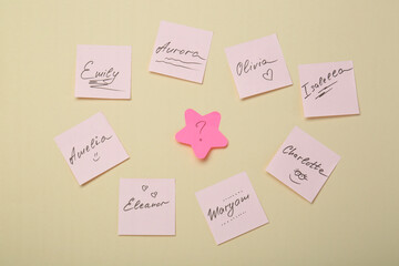 Choosing baby name. Paper stickers with different names and question mark on beige background, flat...
