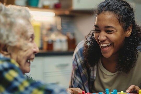 A senior and a young child with obscured faces are engaged in playing a colorful board game