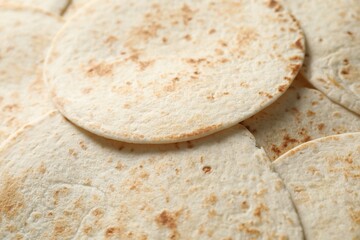 Many tasty homemade tortillas as background, closeup