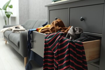 Cluttered room. Clothes in mess all around place