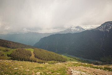 Picturesque view of mountain hill, forest, sky and clouds. Scenic nature landscape. Summer vacation travel