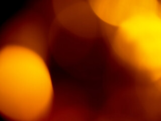 Light orange warm color light leak on dark background for design use and special effects.