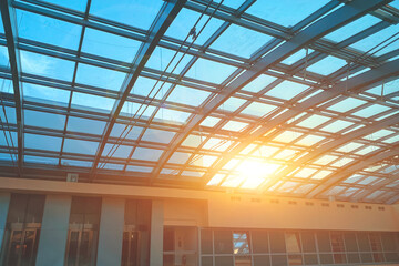sunset through the glass roof, metal frame and glass ceiling