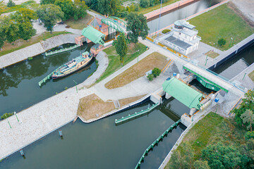 Aerial view of river lock between canal and river, river dam