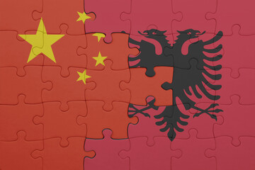puzzle with the colourful national flag of albania and flag of china .