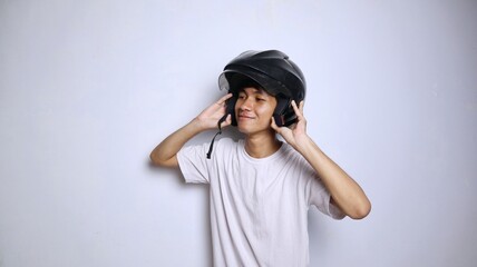 Naklejka premium young Asian man in white shirt gesturing using a helmet