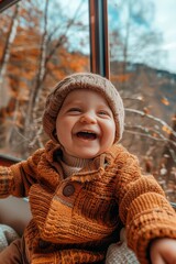 Cheerful little boy looking out with joy through the train s window with eager anticipation