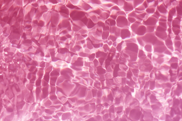 Pink water bubbles on the surface ripple. Defocus blurred transparent red colored clear calm water...