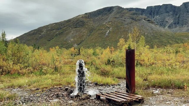 An underground geyser in Khibiny. Lake Maly Woodyavr. The purest water comes out of the ground. Valley of geysers. A thermal spring located in the middle of an endless valley, in a mountainous area.4К