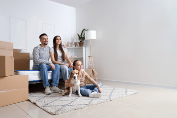 Happy family with dog sitting in bedroom on moving day