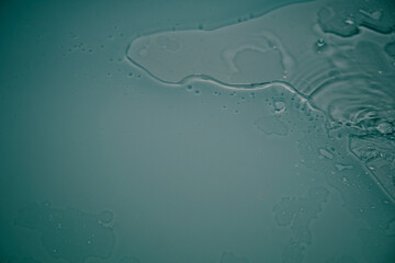 Crystal clear water background. Pure blue water with light reflections in slow motion.