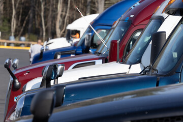 Close-up view of a row of parked trucks, showcasing the diversity of colors and designs in a truck...