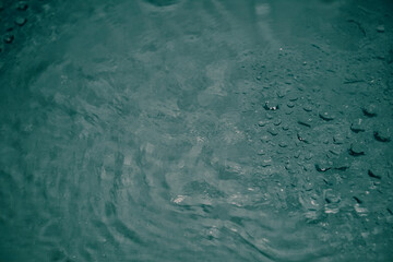 Crystal clear water background. Pure blue water with light reflections in slow motion.