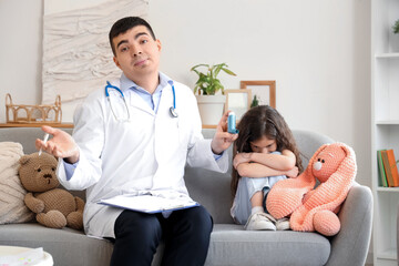 Upset little girl and doctor with inhaler at home