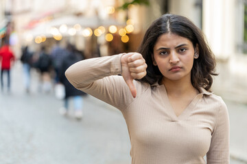 Dislike. Upset Indian young woman showing thumbs down sign gesture, expressing discontent,...