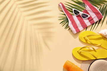 Composition with stylish beach accessories and palm leaf on color background