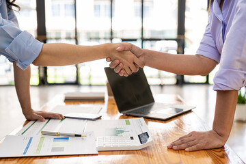 Business people shaking hands and meeting with the above documents to hire a partner or work...