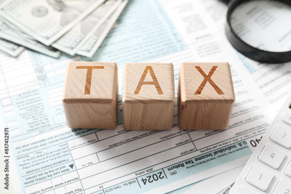 Wall mural wooden cubes with word tax on documents, closeup