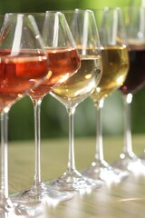 Different tasty wines in glasses on table