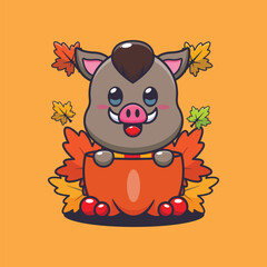 Cute boar in a pumpkin at autumn season